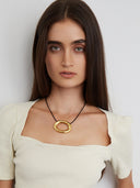 Black cord necklace with gold plated oval