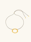 Black cord necklace with gold plated oval