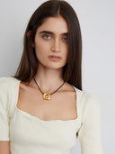 Black cord necklace with gold plated square